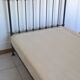 Old bed in black iron and brass