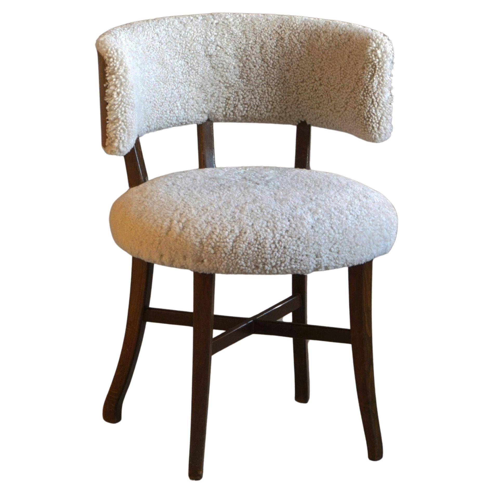 A modern Danish elegant low-back chair, reupholstered in lambswool, 1940s.