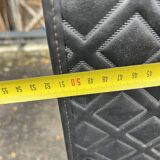 Contemporary wardrobe in black faux leather with diamond pattern and gold handles.