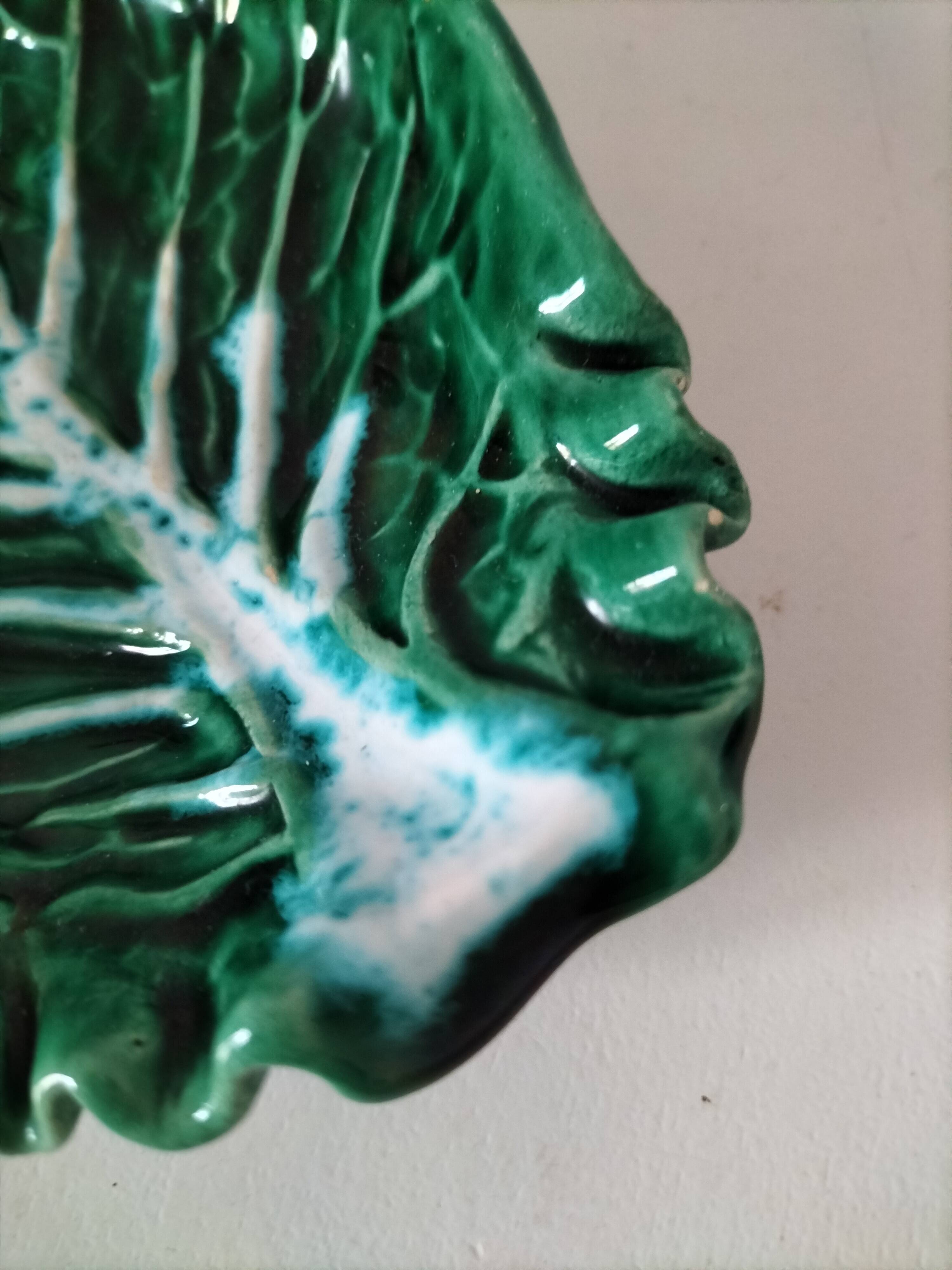 Vintage green slipware bowl in the shape of a cabbage leaf.