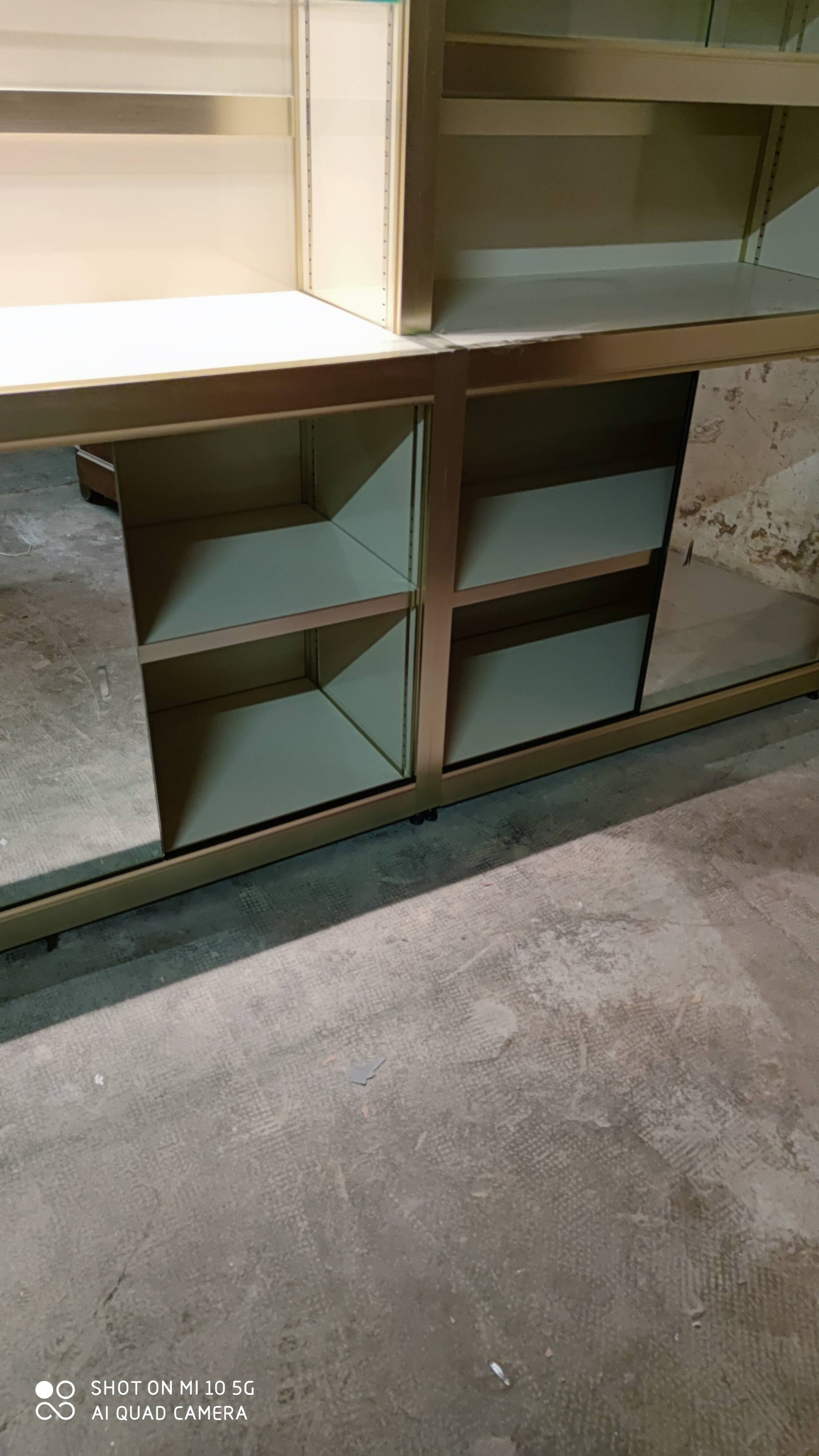 Ivory-colored and matte gold anodized aluminum display bookcase