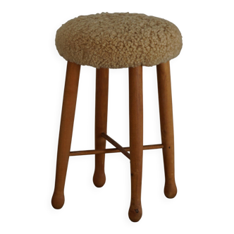 Danish sculptural stool from the mid-century modern period with a lambswool seat, 1960s.