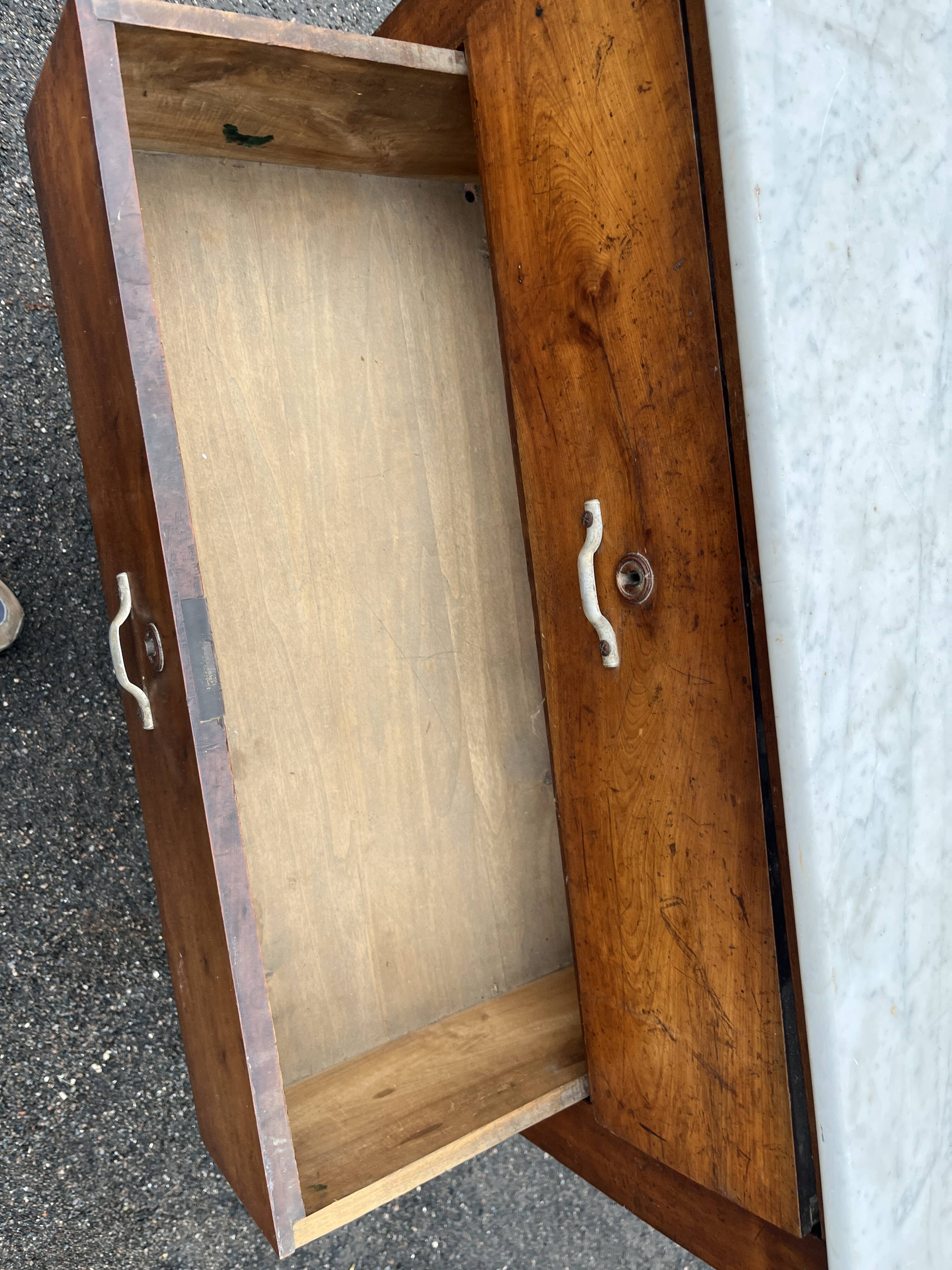 Antique 19th-century wooden chest of drawers with a marble top