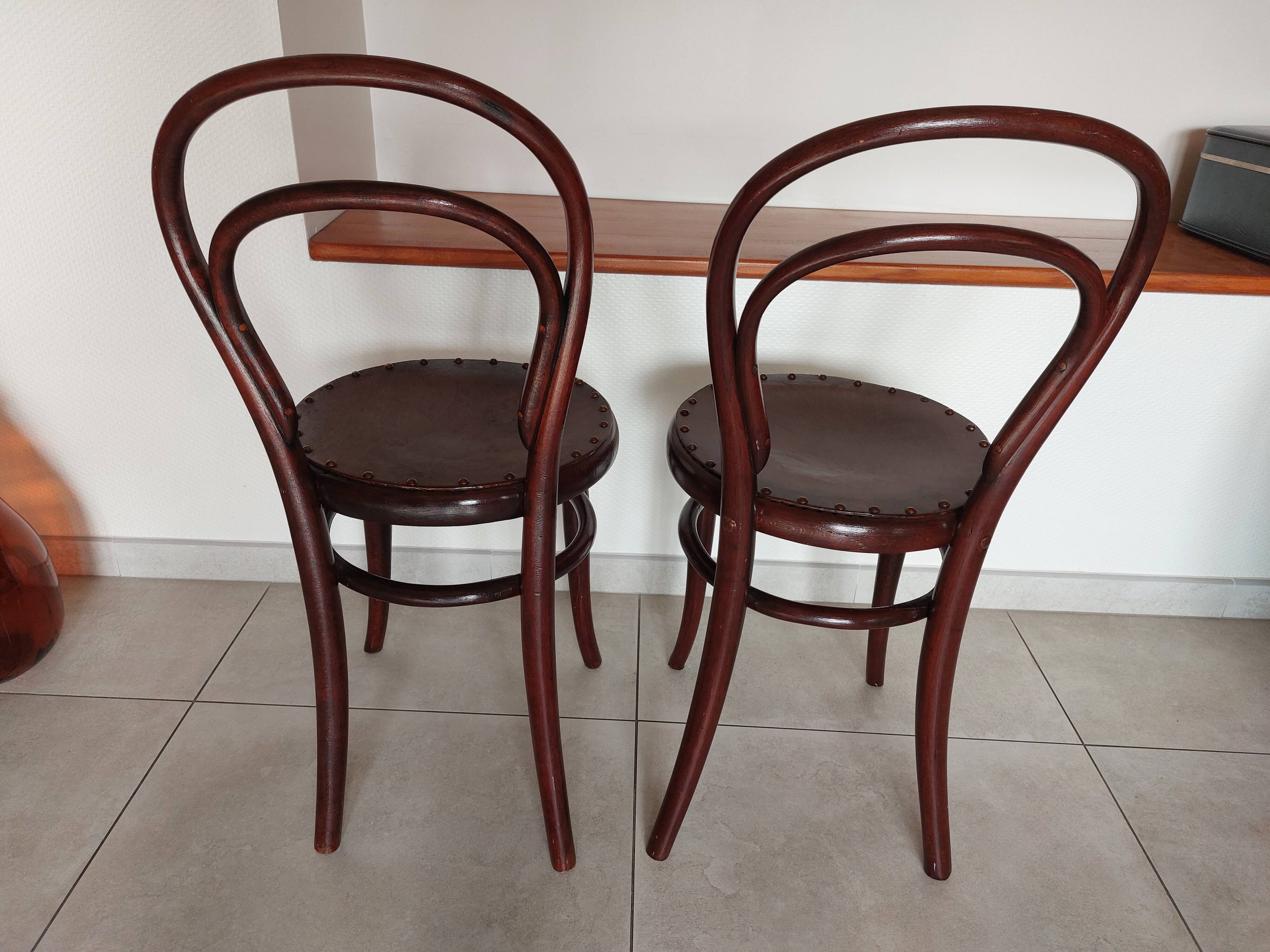 pair of round bistro chairs with a pattern on the seat, vintage