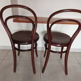 pair of round bistro chairs with a pattern on the seat, vintage