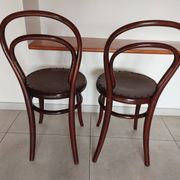 pair of round bistro chairs with a pattern on the seat, vintage