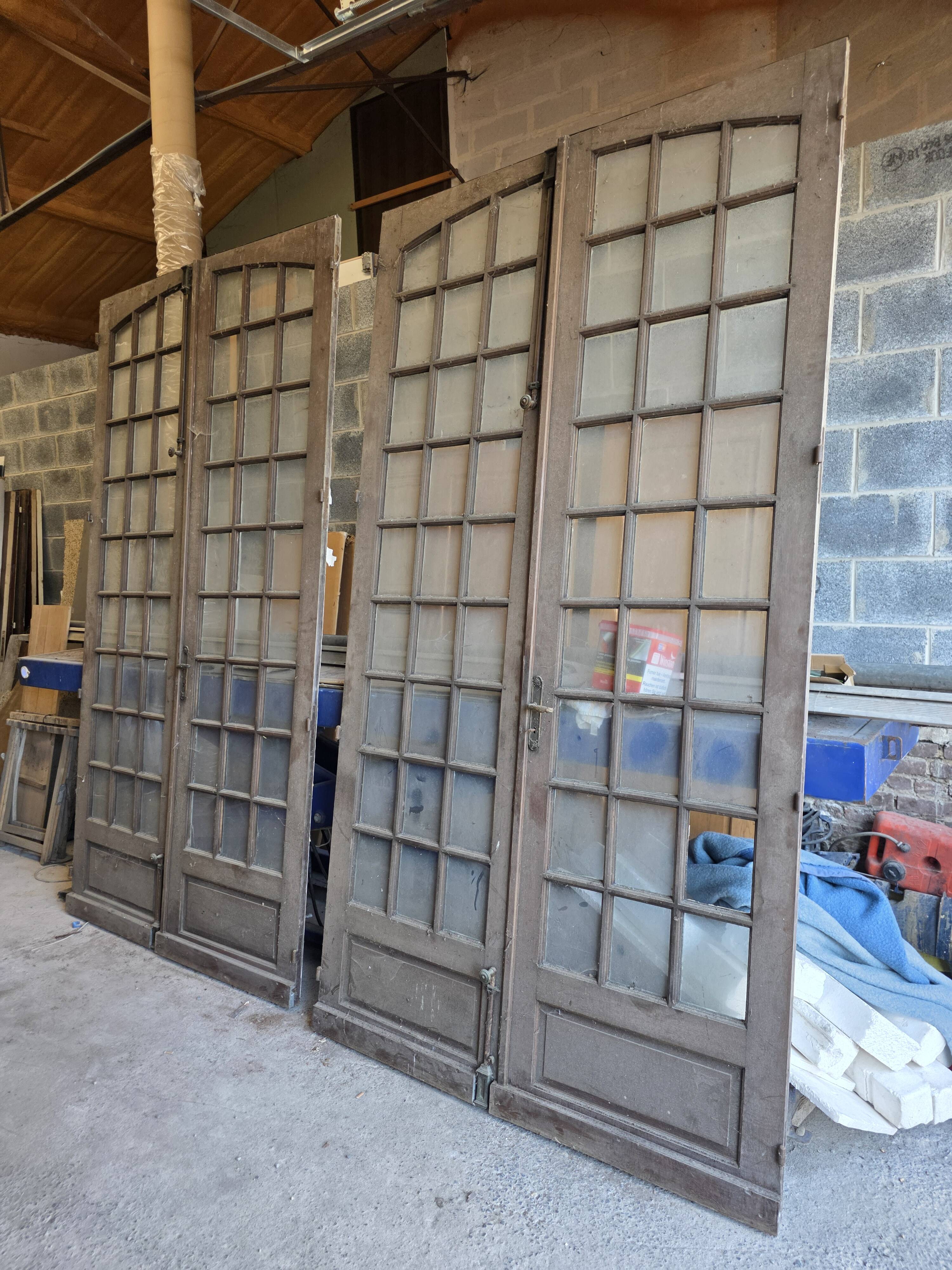 Two pairs of solid oak doors with small panes.