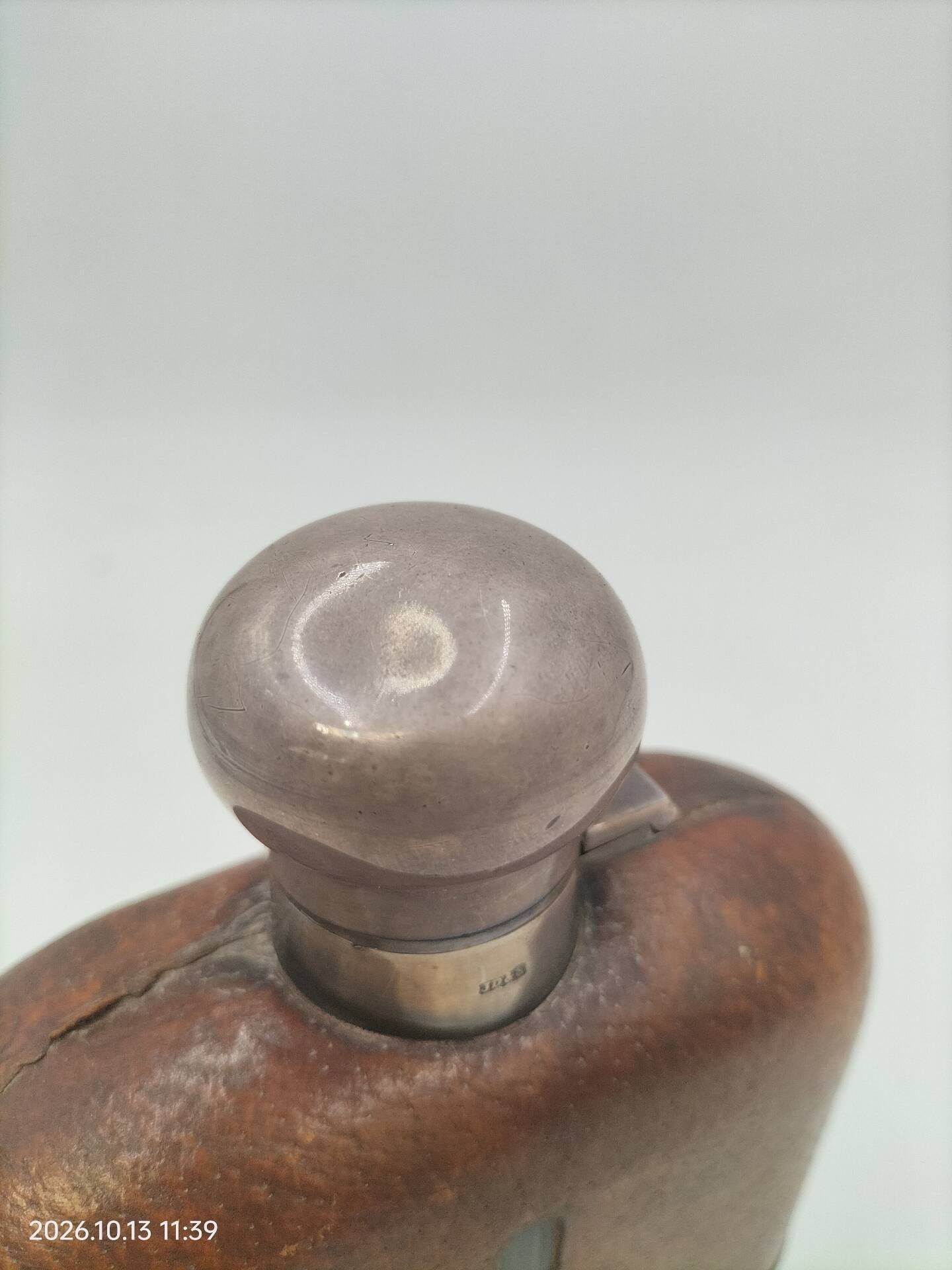Silver-plated metal flask with leather and glass