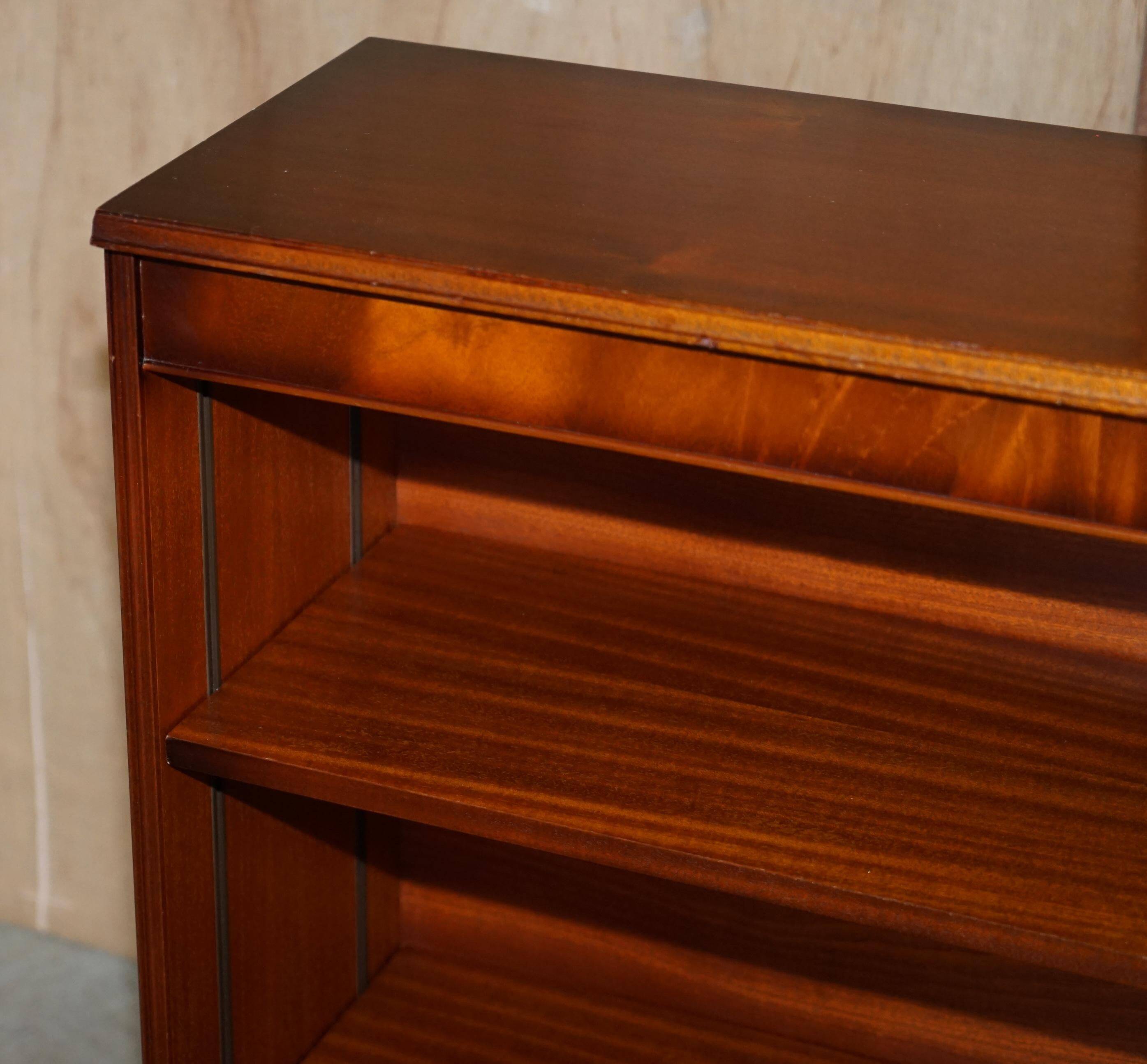 Pair of open dwarf bookshelves in mahogany by Shaws of London.