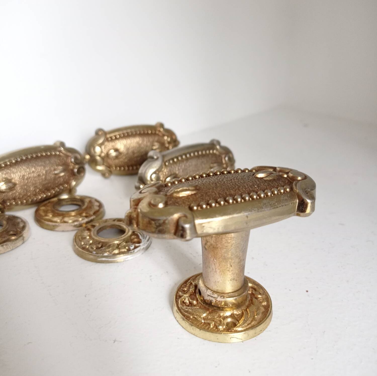 Gold door knobs and rosettes