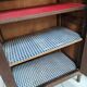 Bonnetière man standing cabinet a door