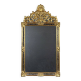 Miroir en bois sculpté et doré de style Louis XV, XXe siècle