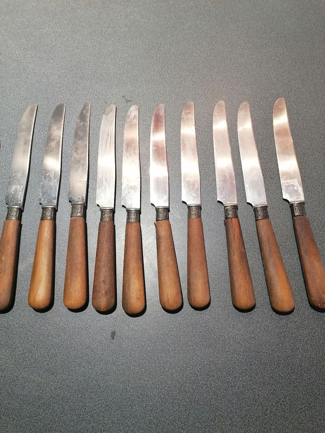 Old table knives and dessert knives, wooden handles, stainless steel blades
