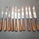Old table knives and dessert knives, wooden handles, stainless steel blades