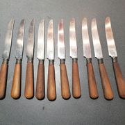 Old table knives and dessert knives, wooden handles, stainless steel blades