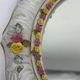 Antique porcelain mirror from Dresden with relief flowers and rococo decoration.