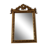 Old pedimented mirror in gilded wood