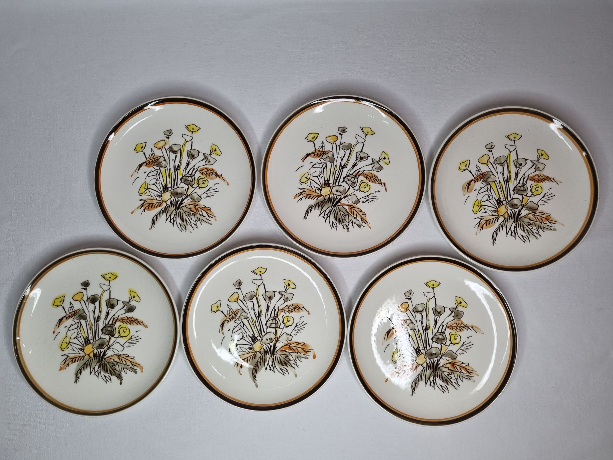 Six vintage dessert plates decorated with flowers from the Gien earthenware factory