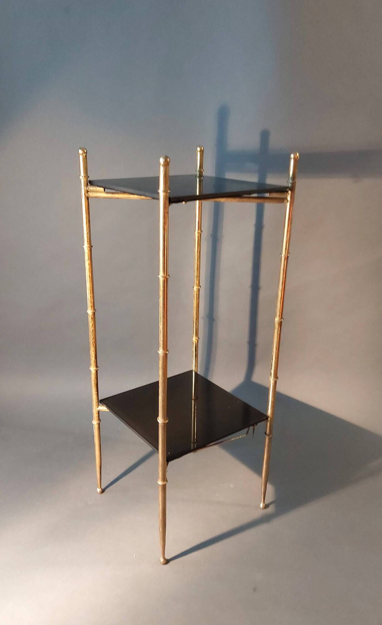 Pedestal table in patinated gilded brass faux foldable bamboo.