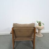 Brown-grey armchair with an oak frame.