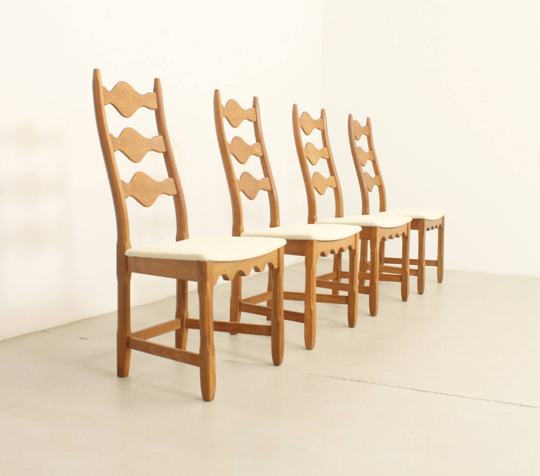 Four oak dining chairs by Henning Kjaernulf.