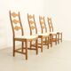 Four oak dining chairs by Henning Kjaernulf.