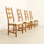 Four oak dining chairs by Henning Kjaernulf.