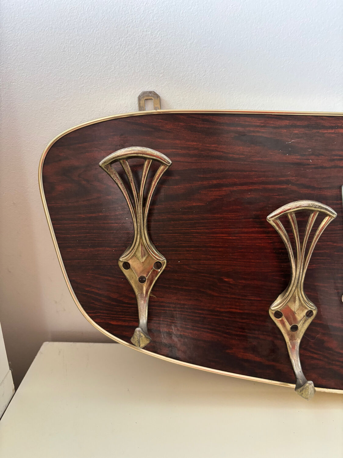 Wood and brass coat rack, 1960