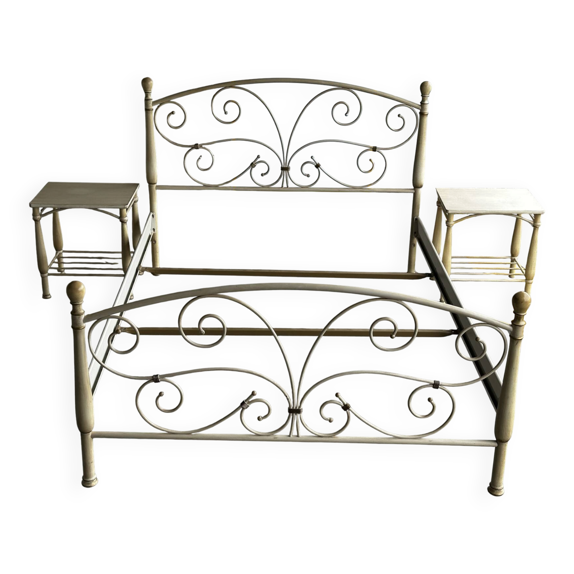 Patinated metal and wood double bed with integrated bedside tables.