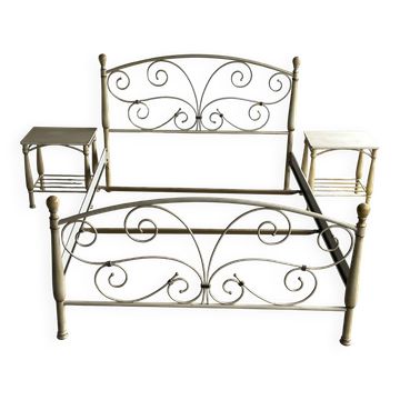 Patinated metal and wood double bed with integrated bedside tables.