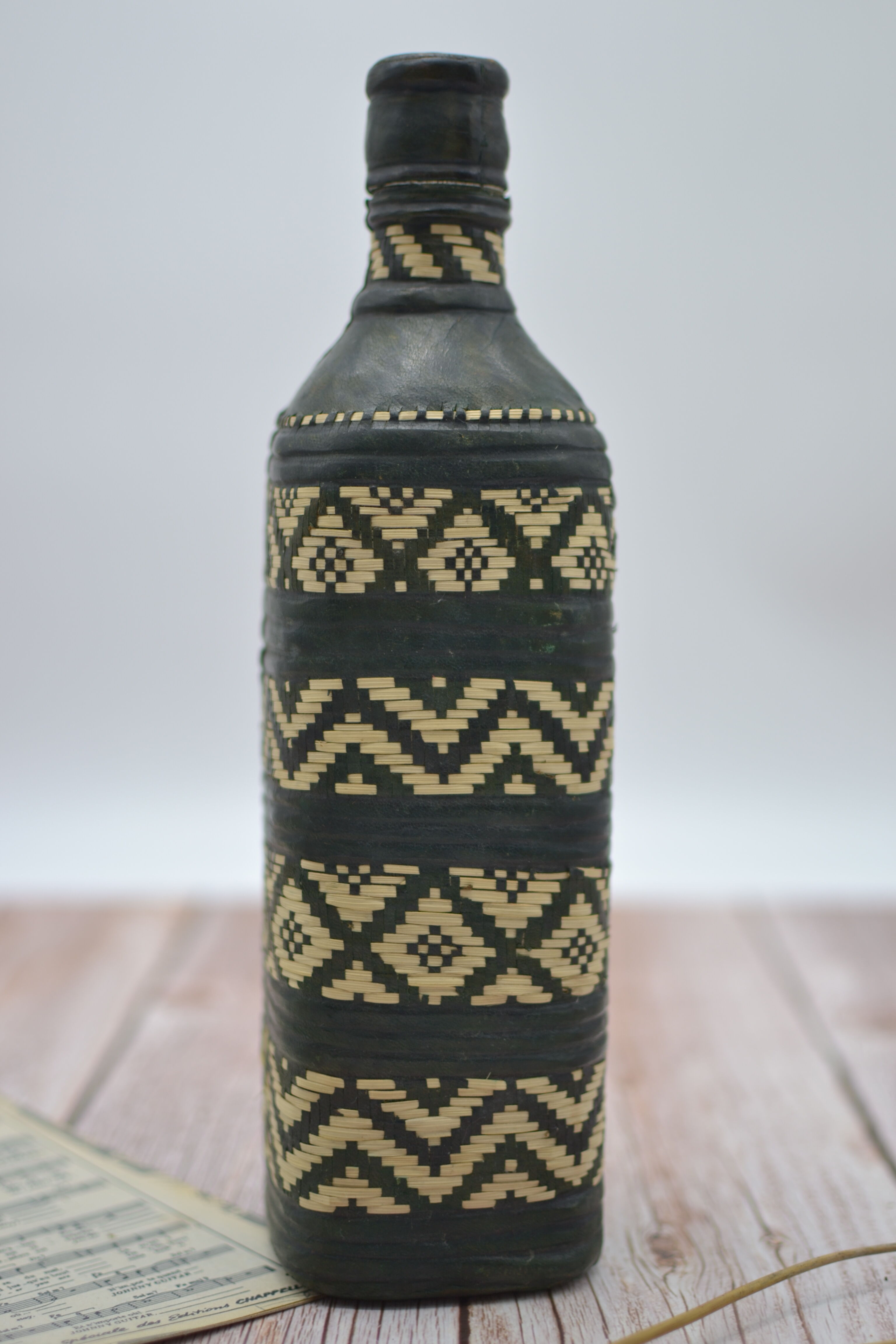 Set of 2 decorative vintage bottles covered with leather & wicker