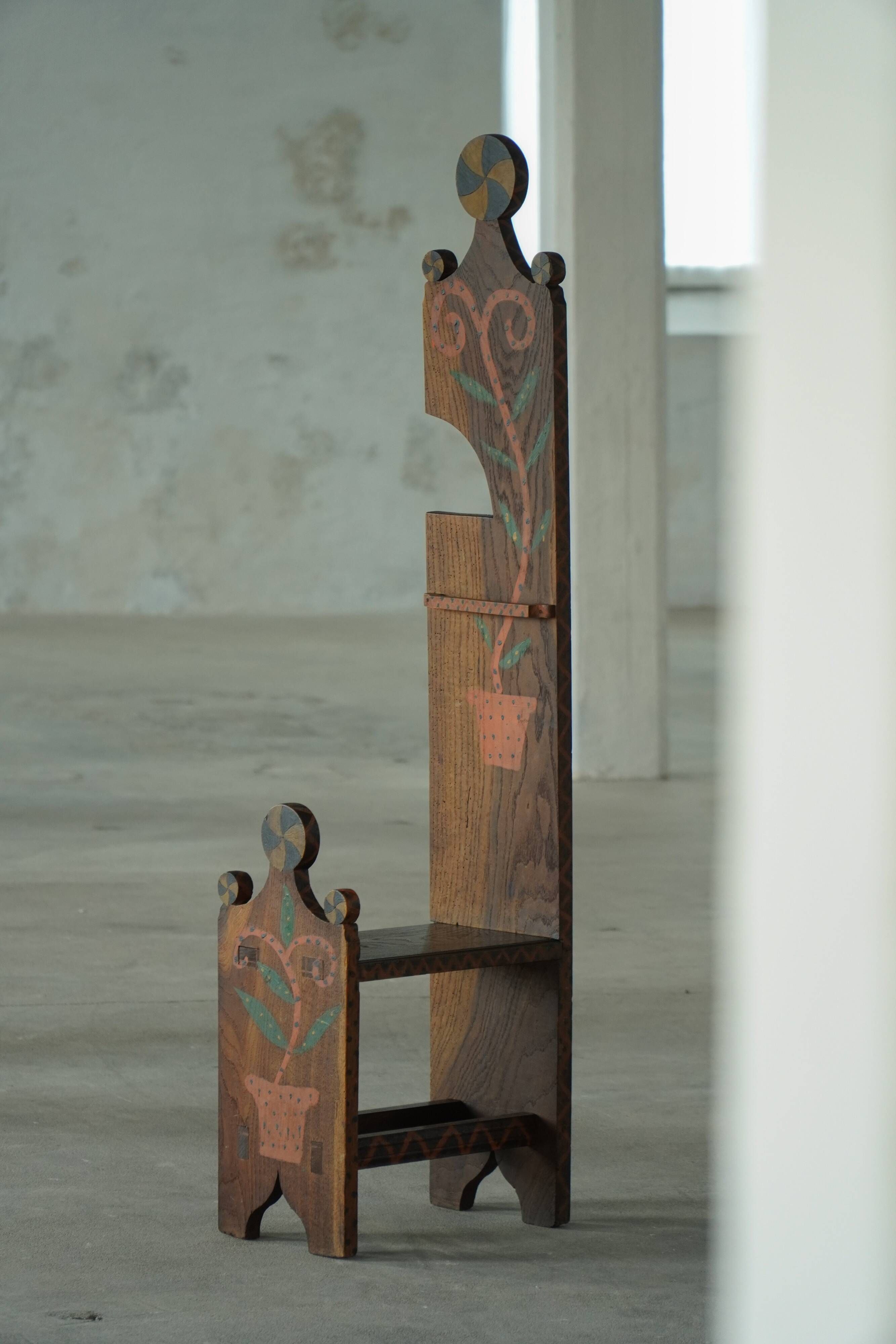 Danish popular art chair with a high back, made of oak, featuring hand-painted decoration, dated 1876.