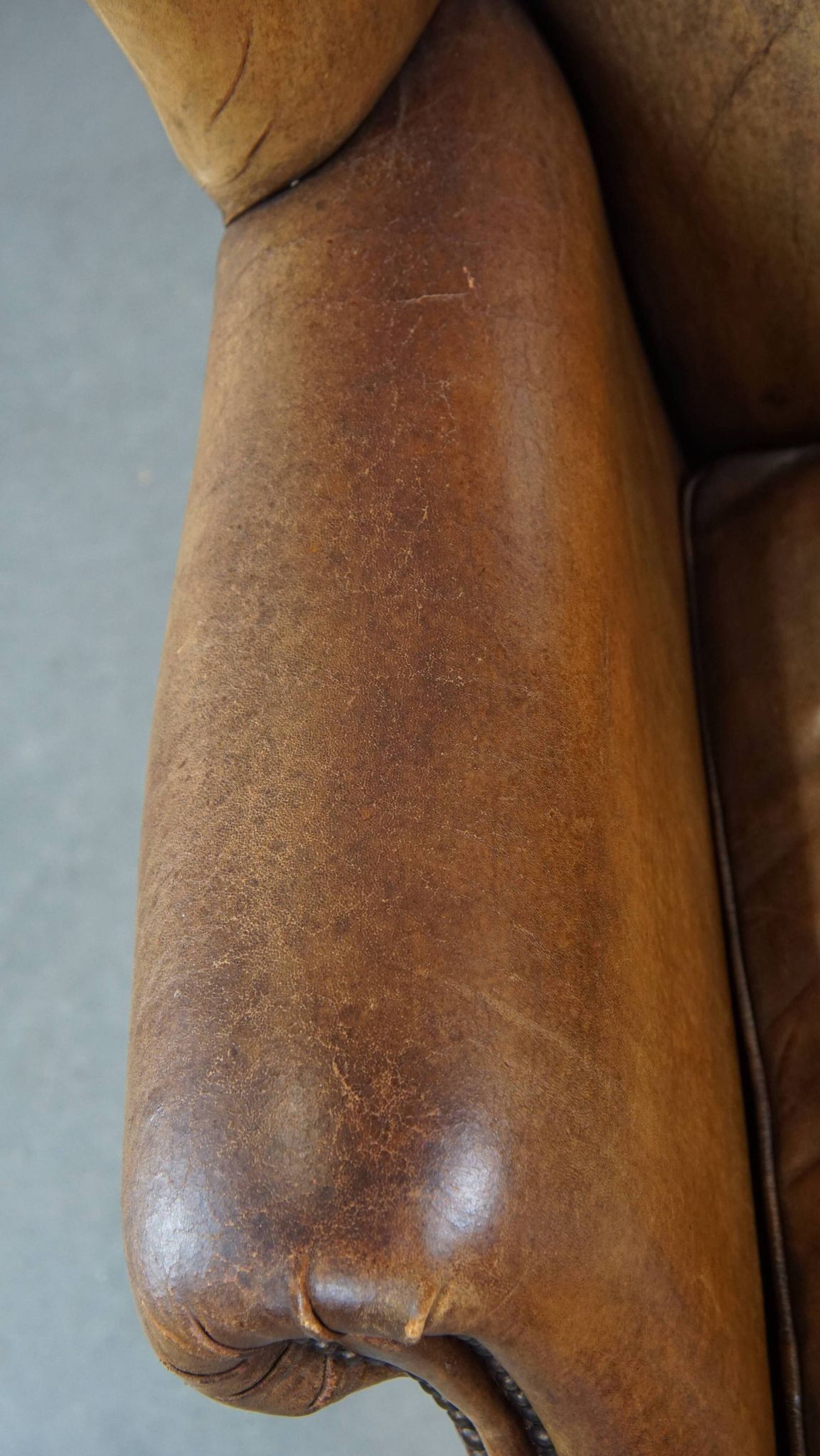 Patinated sheep leather wingback armchair