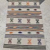 White carpet with multicolored Berber patterns woven hands