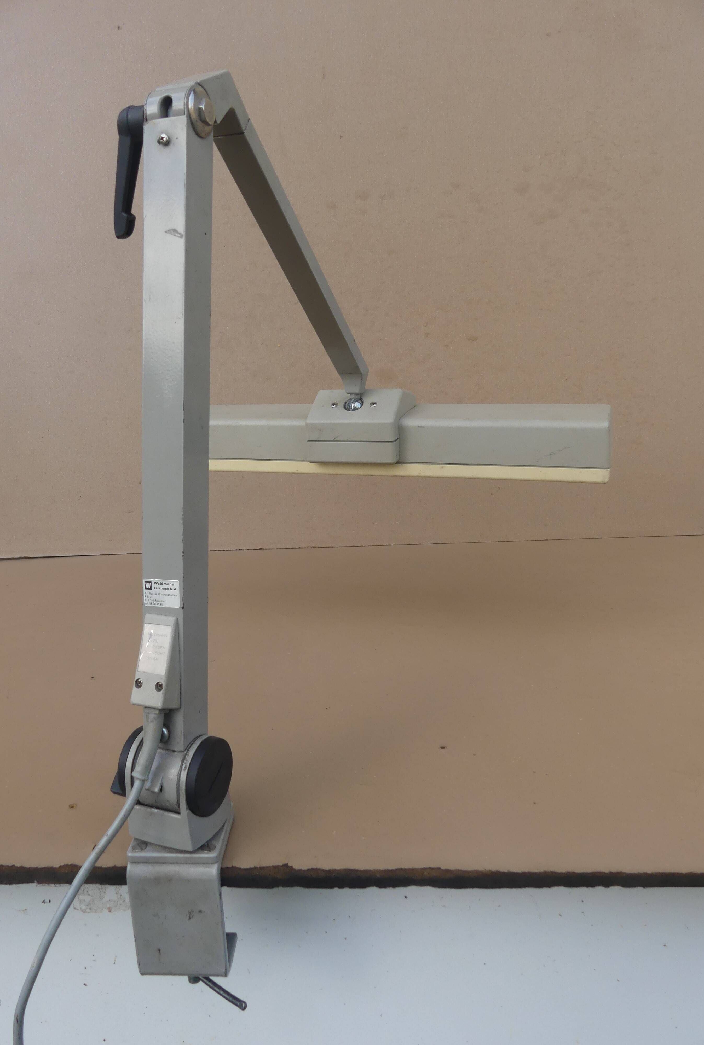 WALDMANN articulated workshop lamp with two industrial clamp arms for architects.