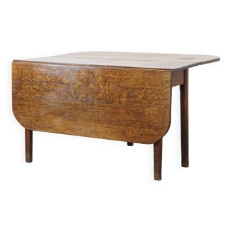 Antique oak drop-leaf dining table from the late 19th century