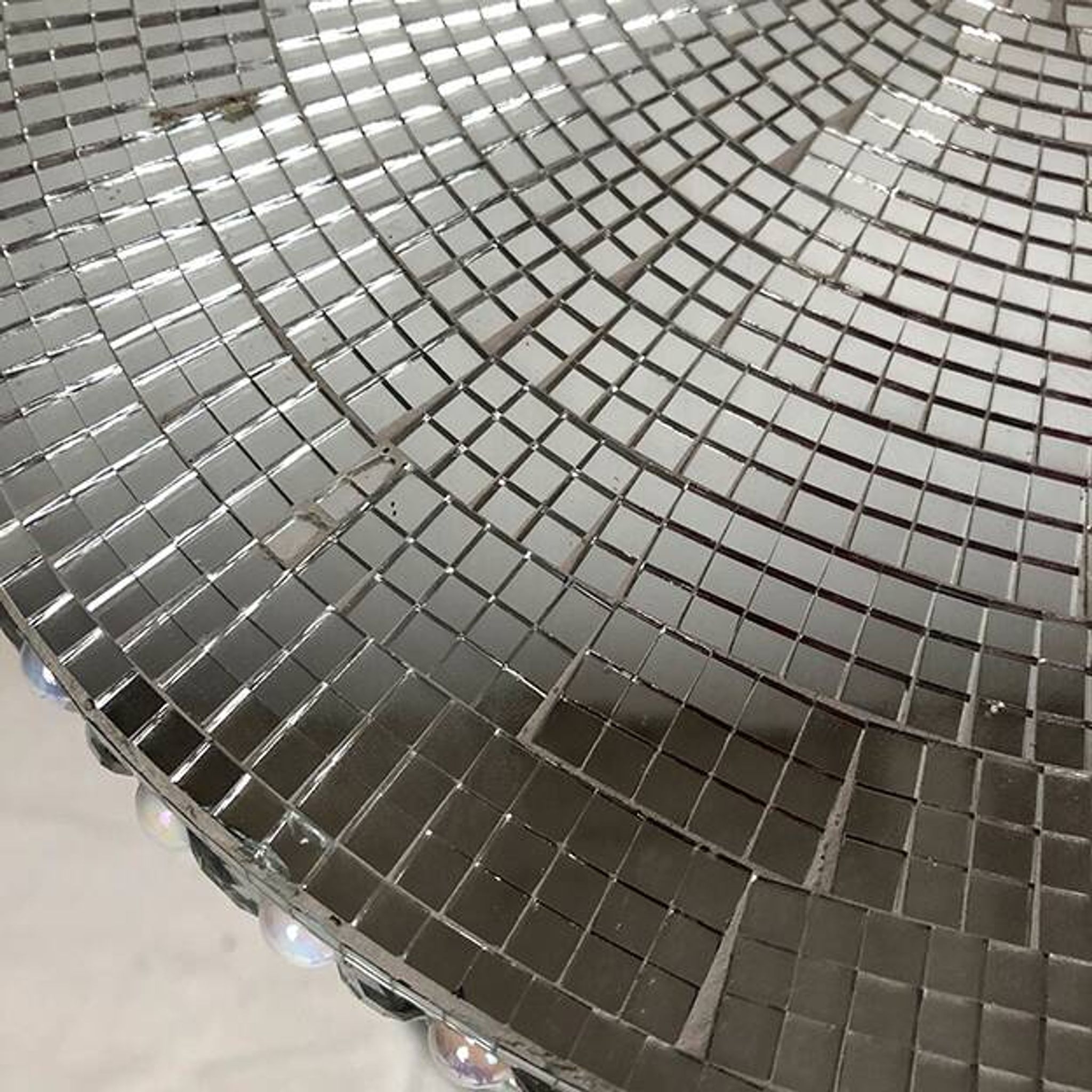 Small wooden pedestal table entirely covered with mirror mosaic