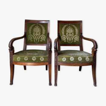 Pair of empire armchairs in tinted walnut, green palmette pattern fabrics, carved dolphin heads