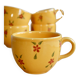 Large vintage ceramic mug in yellow with hand-painted flowers.