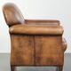Comfortable characterful sheepskin armchair finished with decorative nails