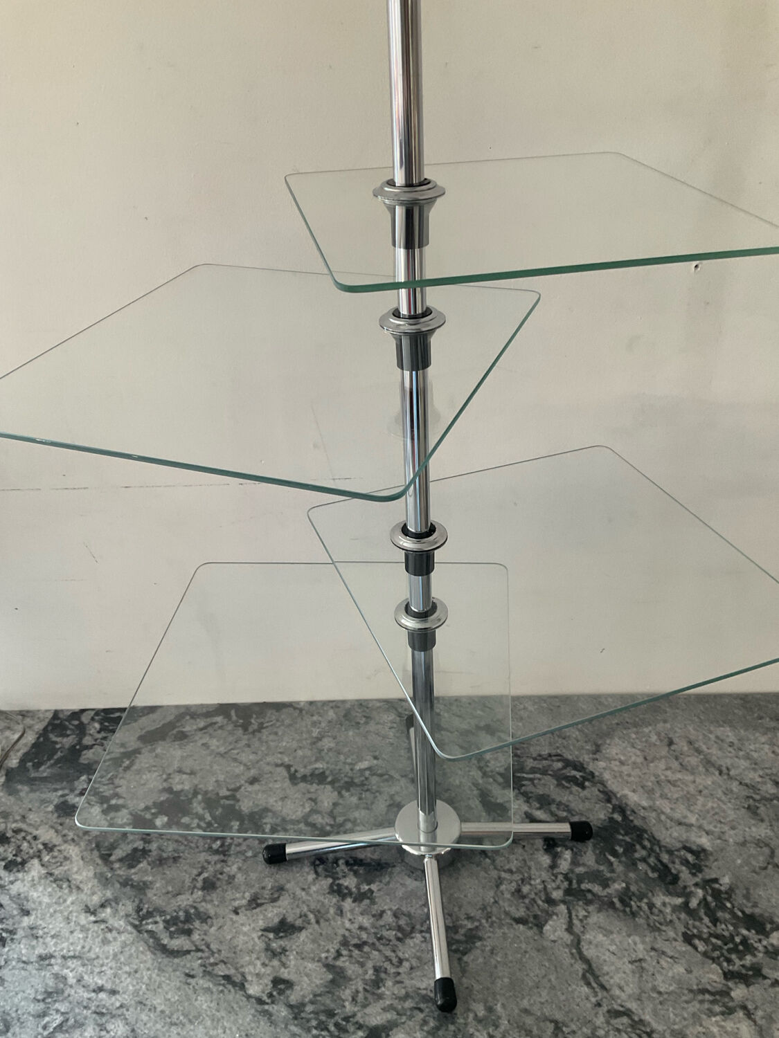 A pair of vintage side tables in glass and chrome metal.