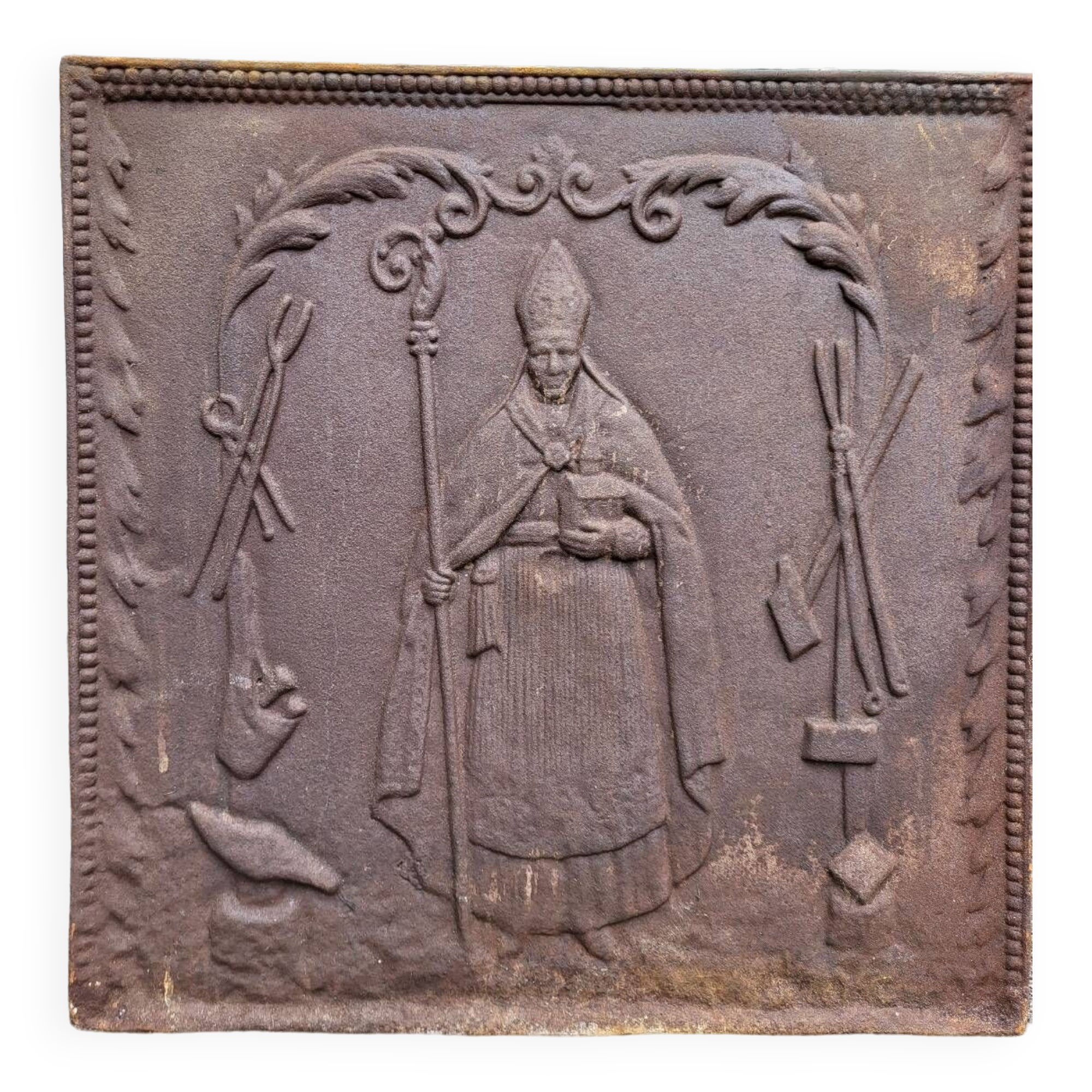 19th century cast iron fireback: bishop blessing the blacksmith's tools
