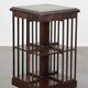 Wooden bookstand with green leather surface and on wheels in English style