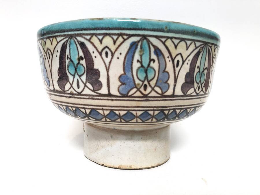 Cup on a ceramic pedestal – blue and turquoise geometric design.