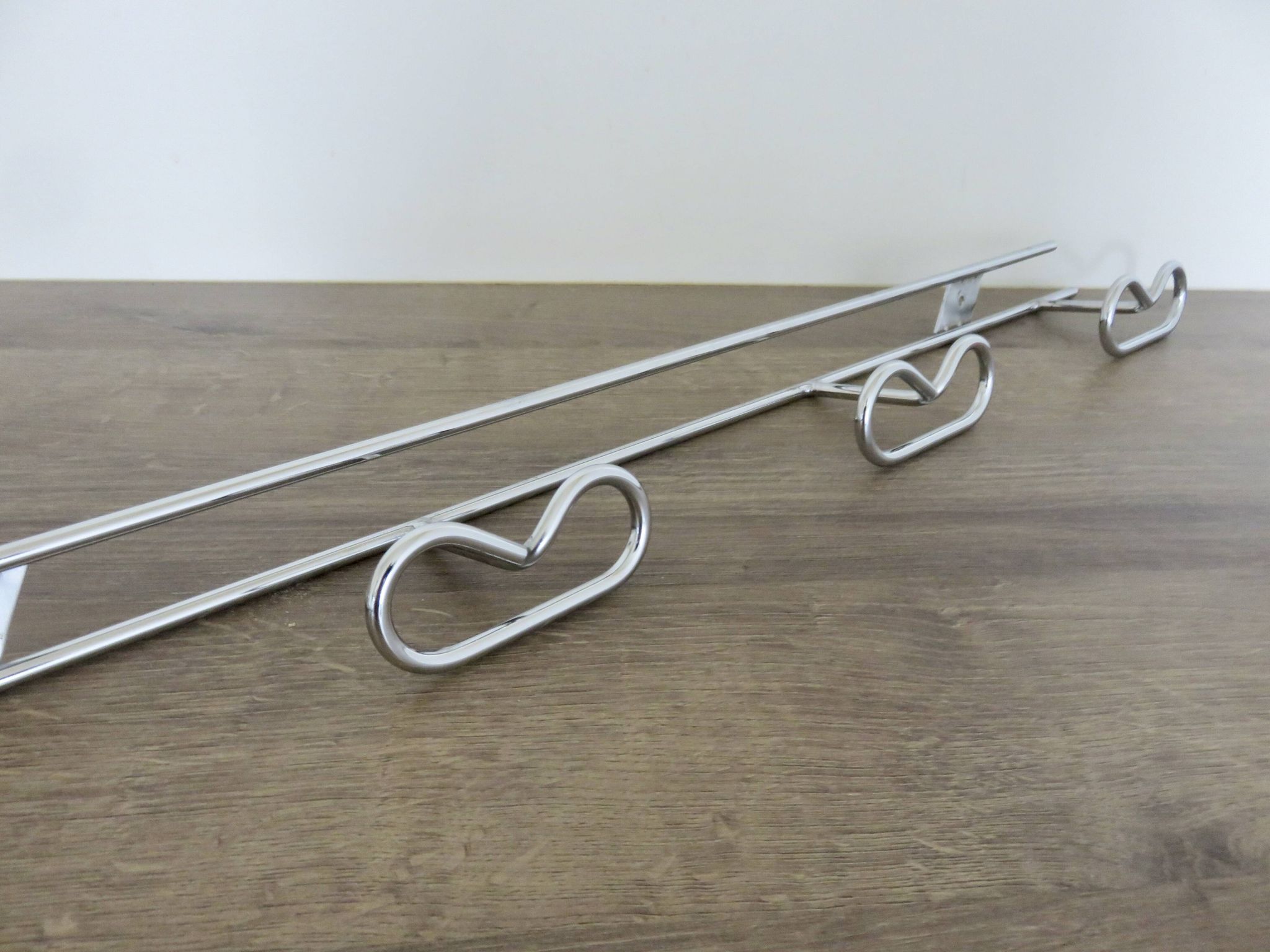 Large vintage wall-mounted coat rack in chrome metal