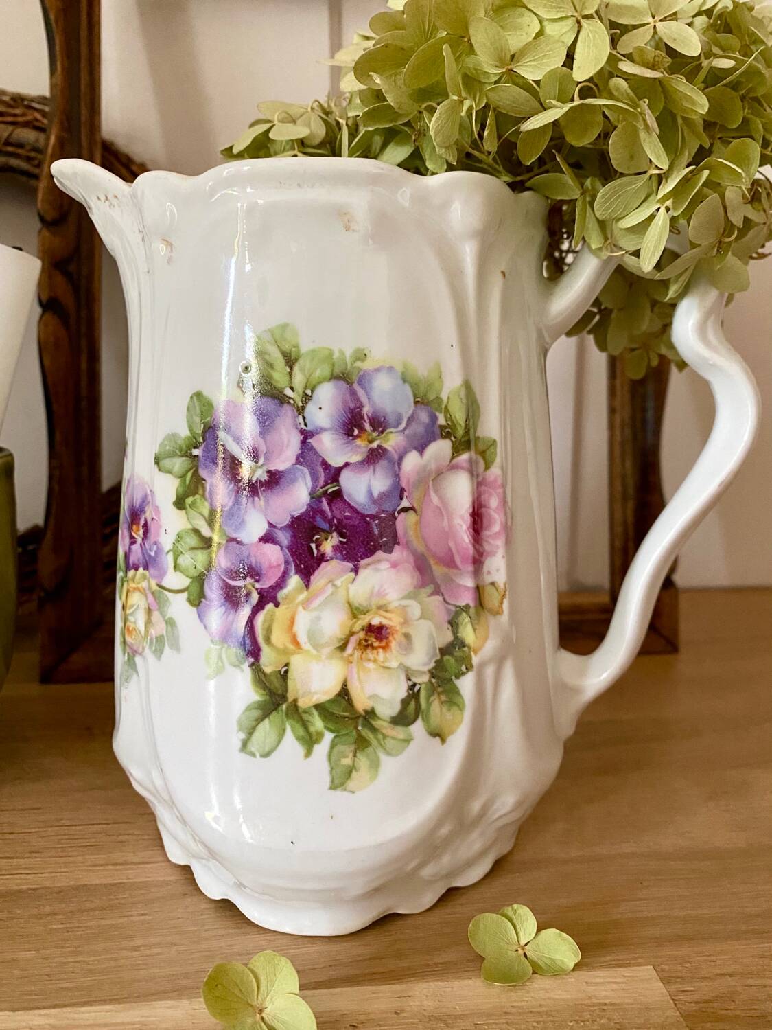 Old ceramic pitcher decorated with flowers