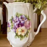 Old ceramic pitcher decorated with flowers