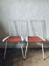 Two metal and straw chairs.