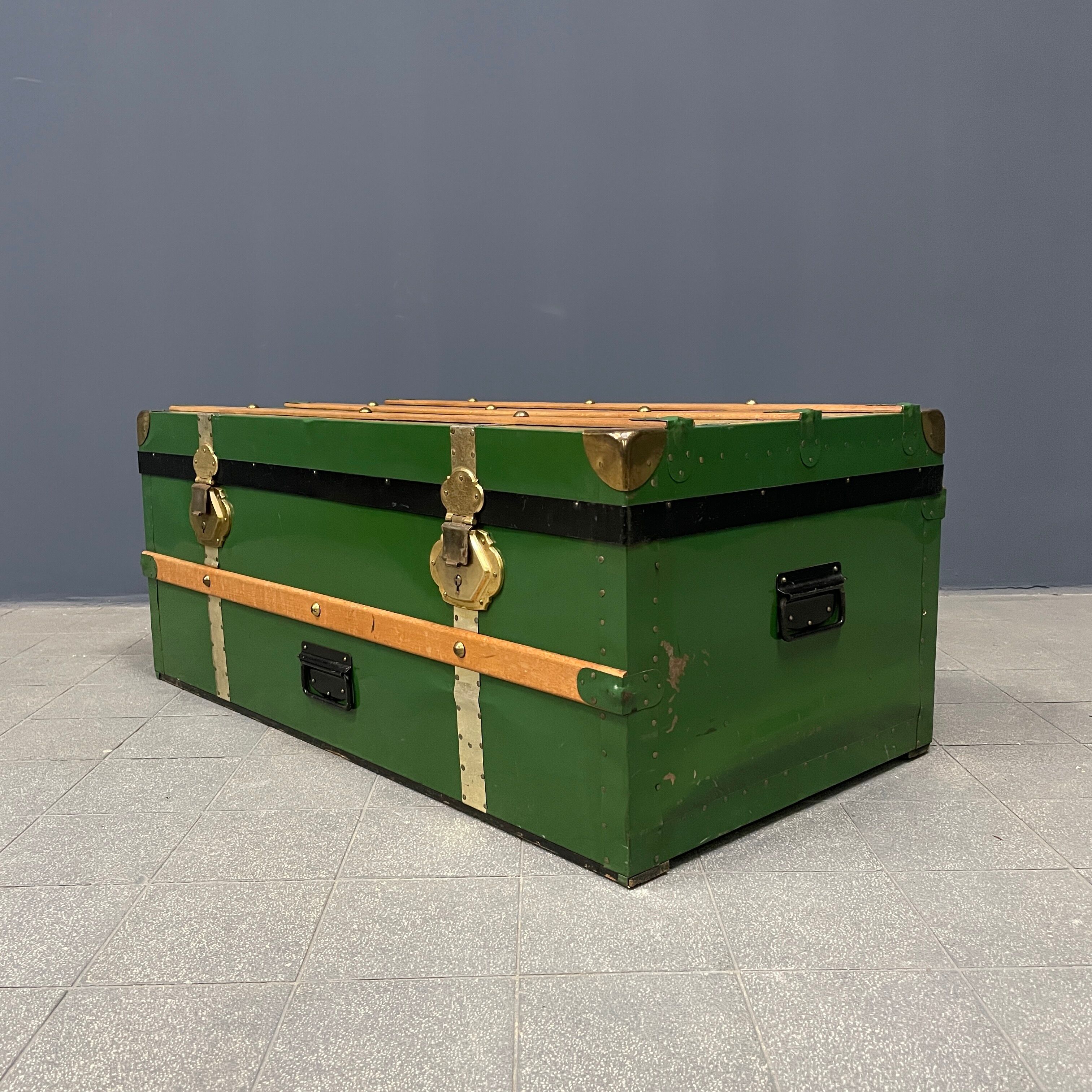 Green metal trunk with wooden sleds