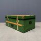 Green metal trunk with wooden sleds